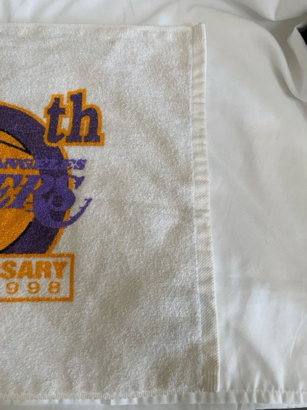 Los Angeles Lakers 50th anniversary towel with team's commemorative logo.